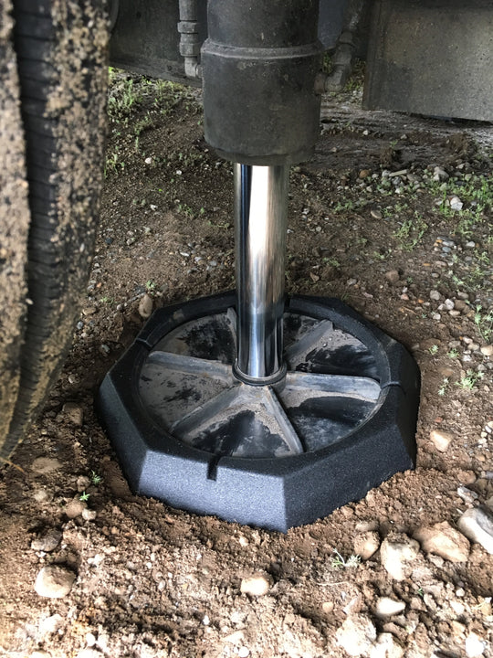 RV SnapPads lowering to concrete ground on leveling jack